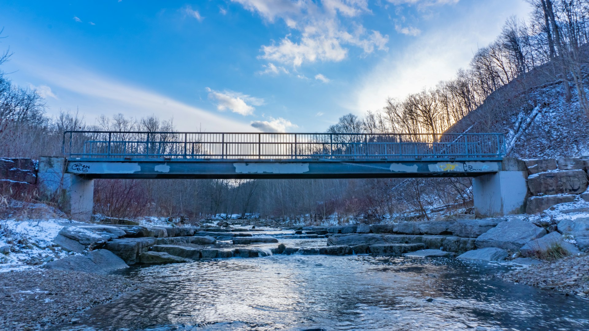 bridge over river under blue sky during daytime